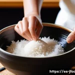 일식조리 기능사 시험 자주 나오는 문제 - A detailed close-up of a sushi chef&rsquo;s hands skillfully washing and preparing sushi rice in a traditi...
